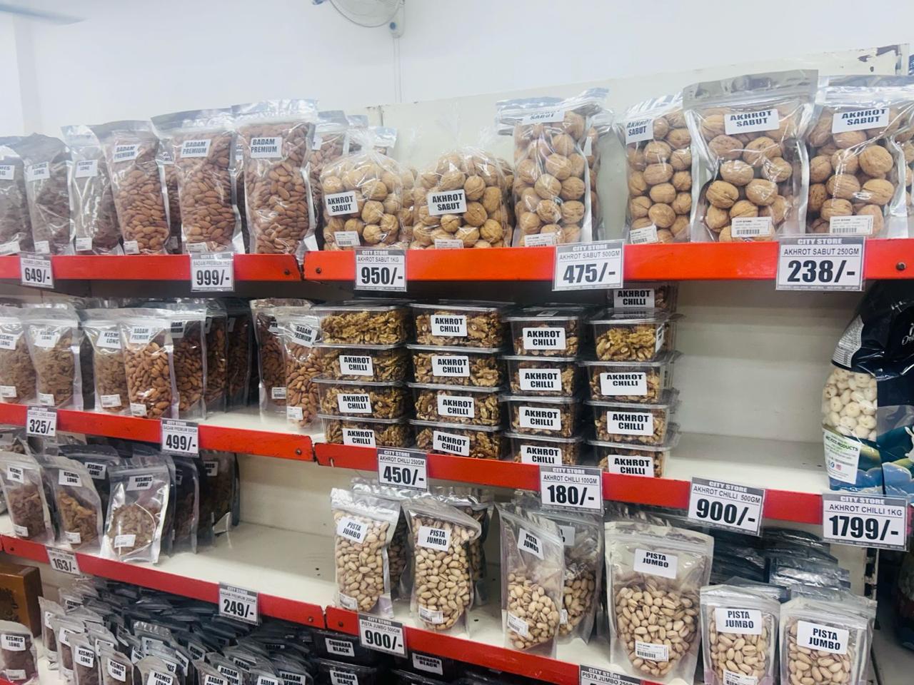 Packed shelves of premium dry fruits with price tags